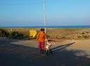 Ojas and her daughter Lyra pedalling for gender freedom by the beach